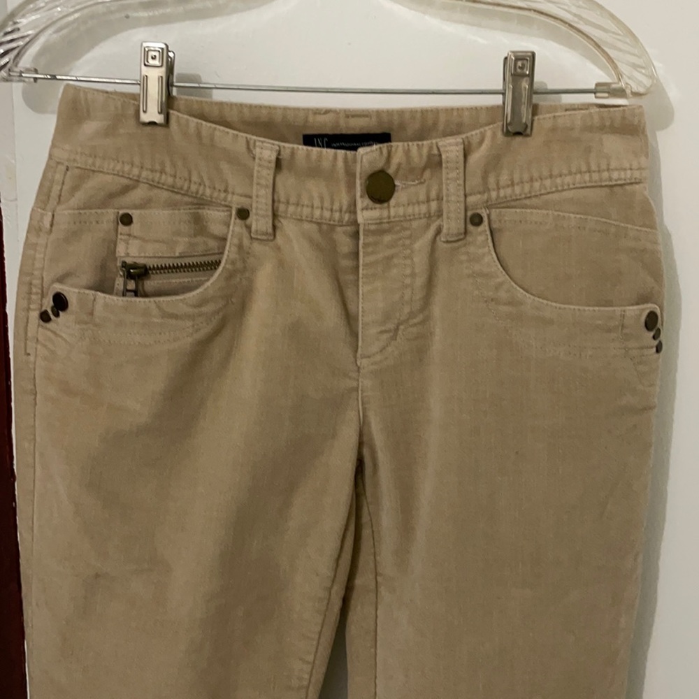 Inc tan, zipper on pockets and lower side pants zipper.